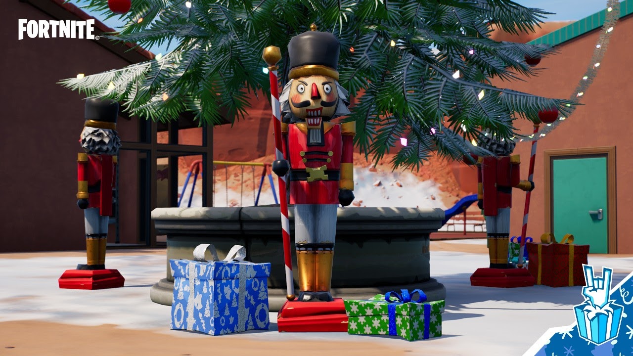 A nutcracker doll sits, surrounded by presents, underneath one of the holiday trees in Fortnite's Winterfest