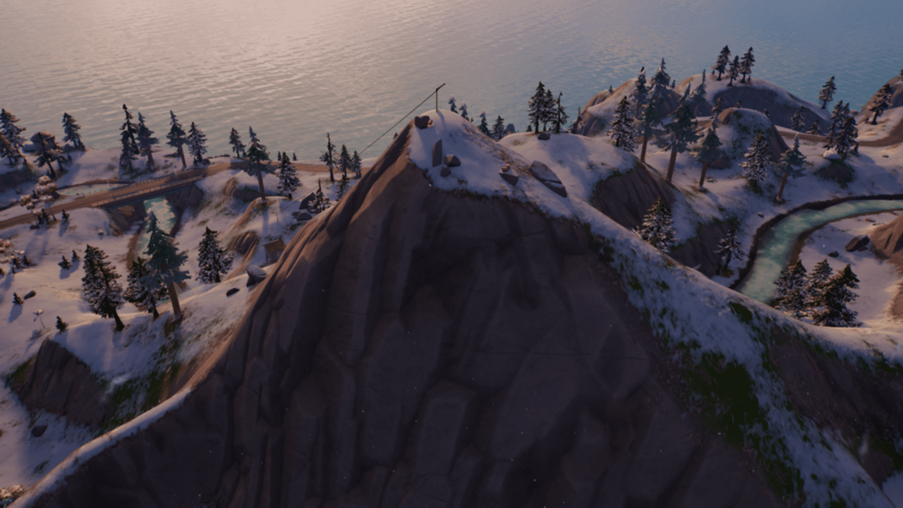 A snowy mountain peak dotted with timber pines in Fortnite Chapter 3