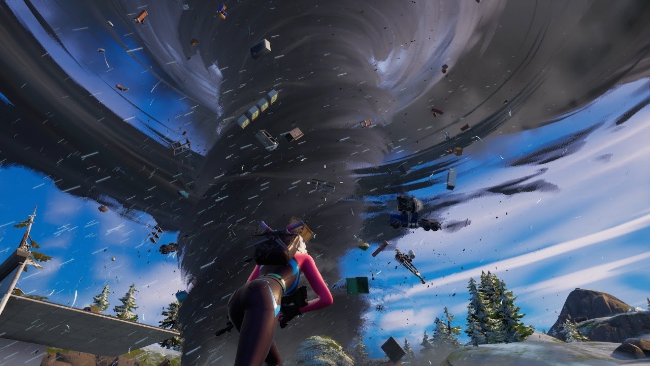 A Fortnite player makes their way toward a massive tornado in game