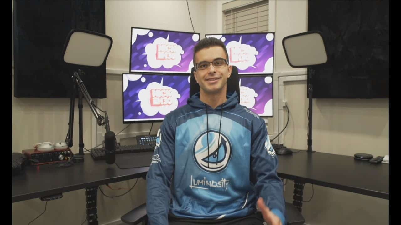 Streamer and Fortnite player Nick “NickEh30” Amyoony sits in front of a four monitor PC setup with a Luminosity hoodie on