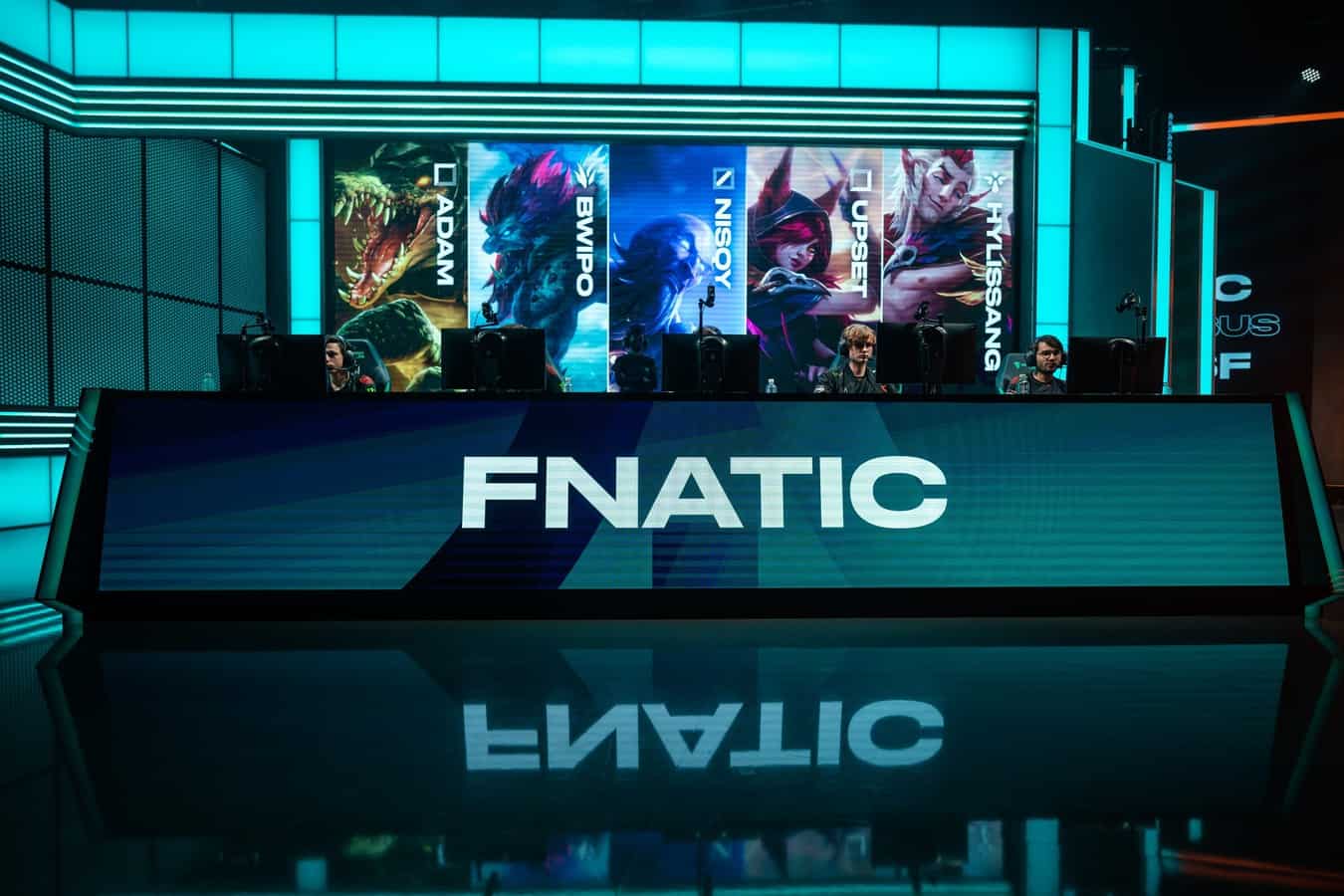 The word "Fnatic" appears on a monitor in front of the Fnatic LoL team in the LEC studio.