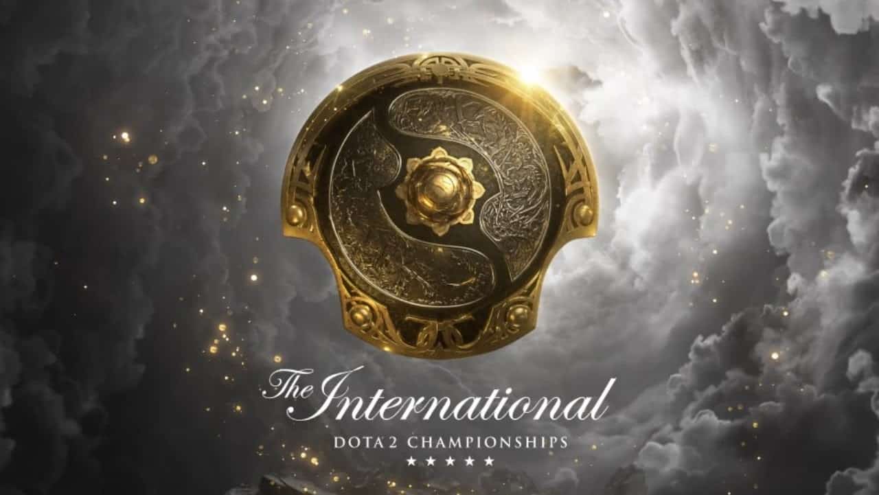 The Aegis of the Immortal shield, set against a cloud filled sky dotted with gold stars and the words "The International Dota 2 Championships" below.