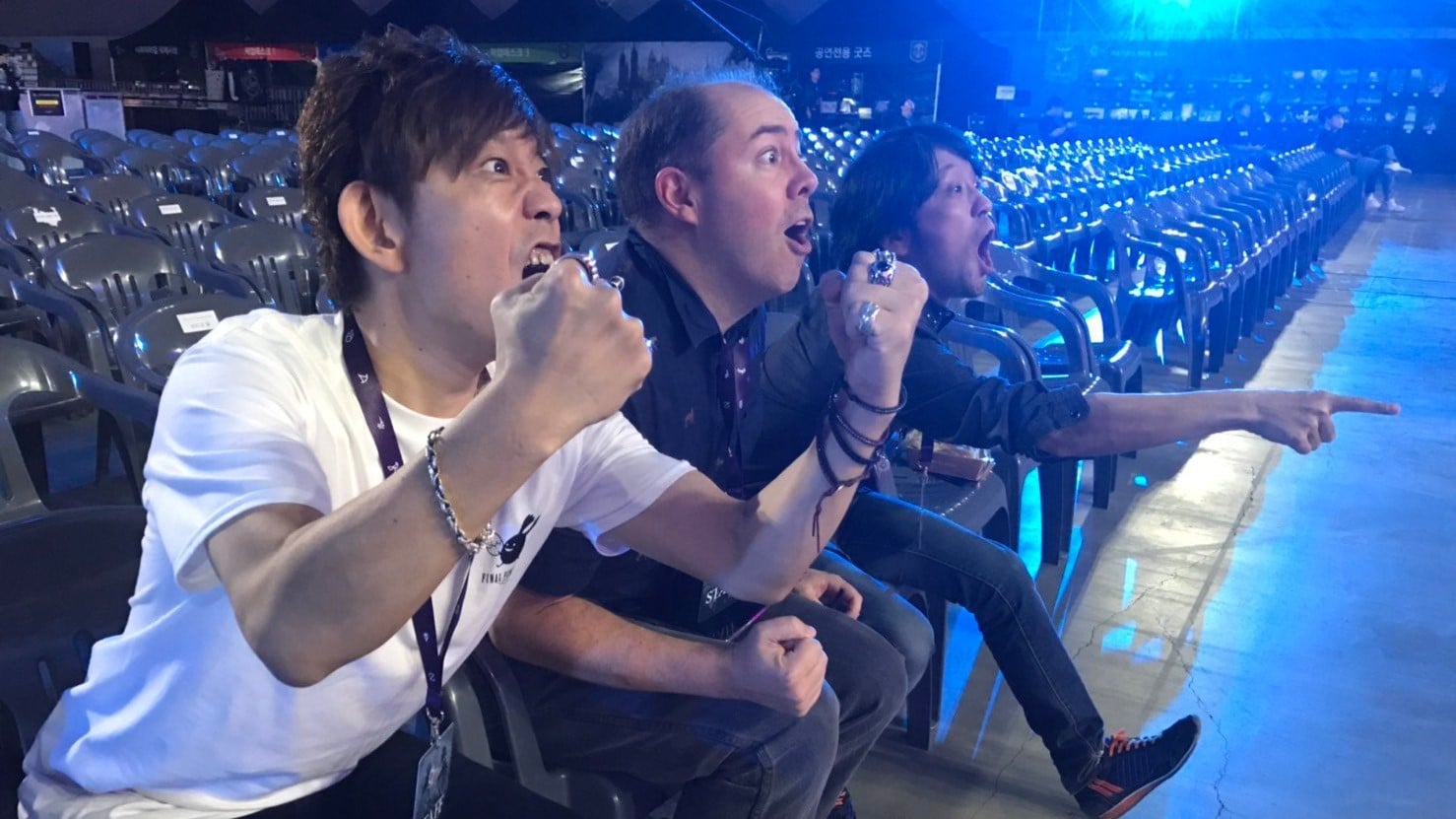 Final Fantasy XIV's development team including Naoki Yoshida and Koji Fox, cheer during a live performance of the game's soundtrack