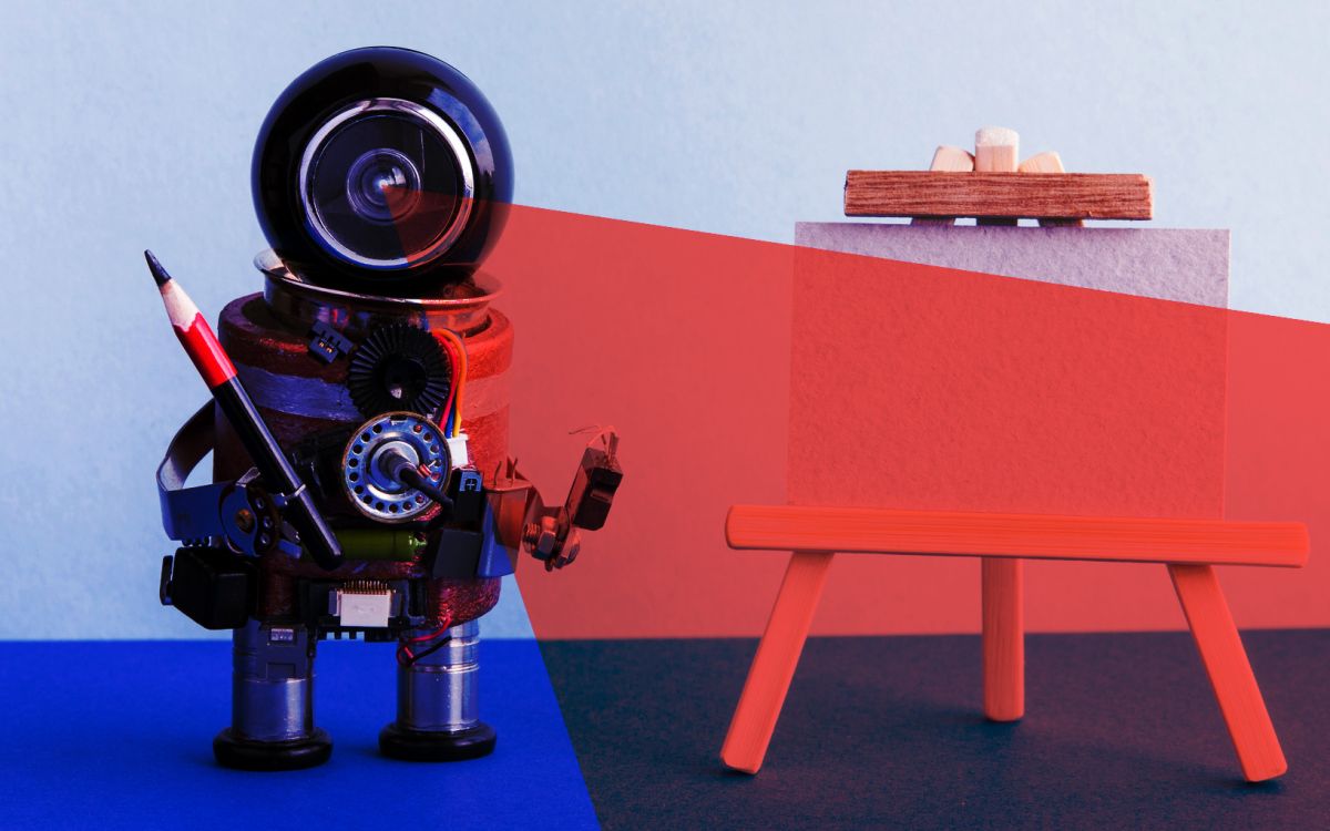 A robot with a camera head holding a pencil next to an easel.