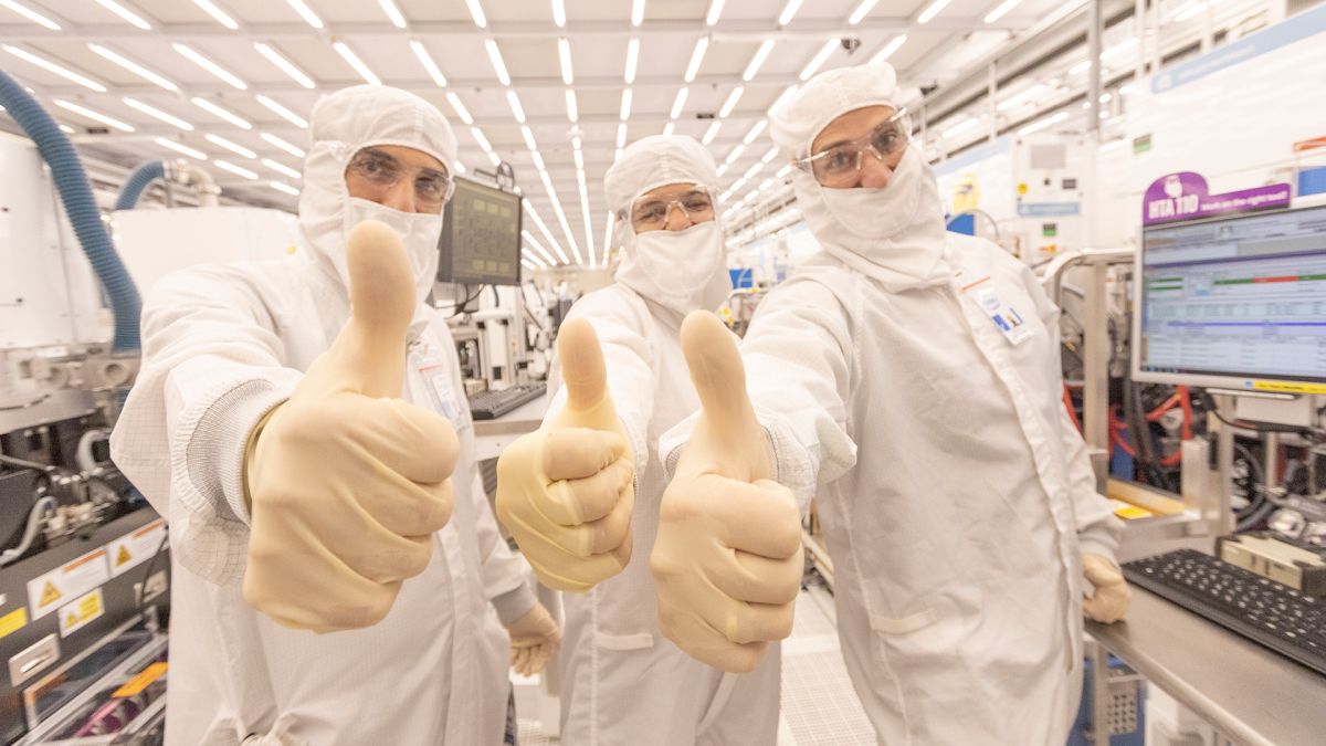 Three engineers give a thumbs up inside Intel