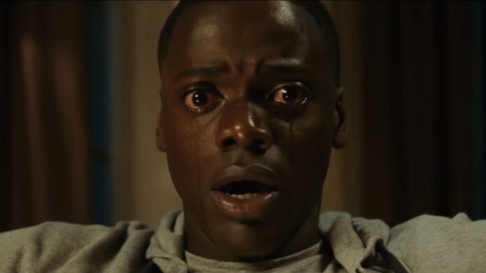 A close-up of Daniel Kaluuya shedding tears in a scene from Get Out.