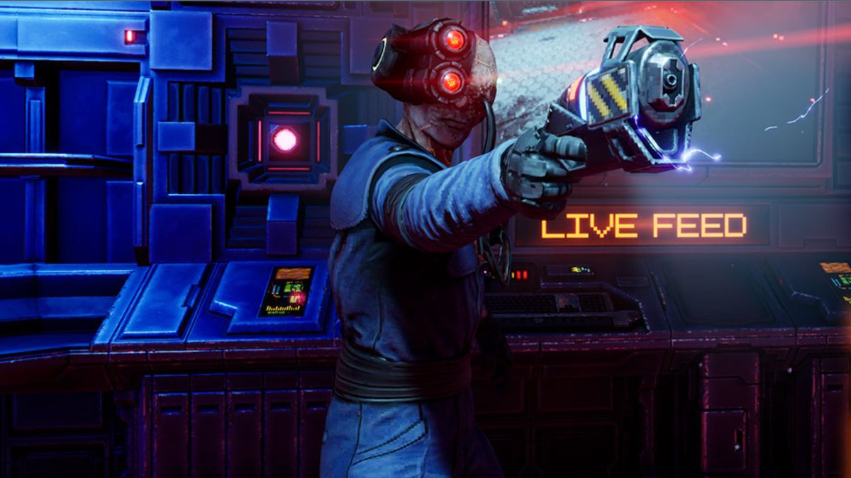 Cyborg man holding a laser pistol in front of monitor that says