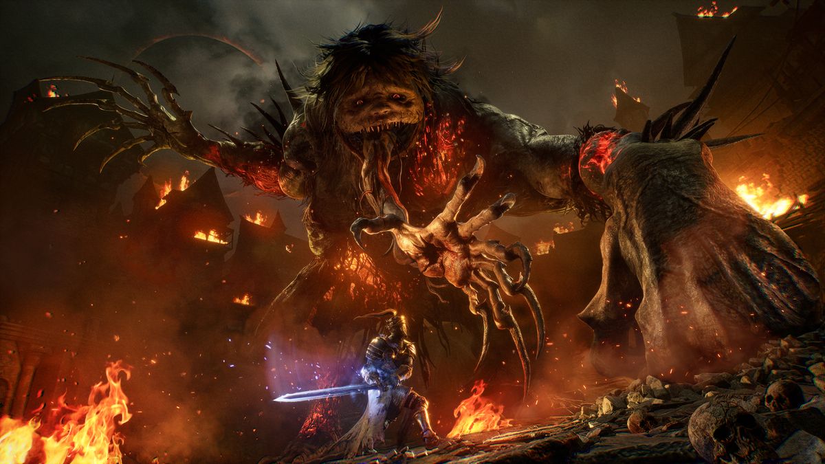 A hero fighting a monstrous giant in Lords of the Fallen. 