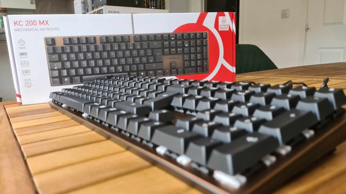 Cherry KC 200 MX gaming keyboard on a wooden table.