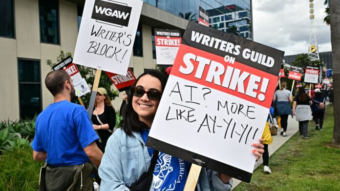 Writer Ilana Pena holds her sign on the picket line on the fourth day of the strike by the Writers Guild of America in front of Netflix in Hollywood, California, on May 5, 2023. - The Hollywood writers