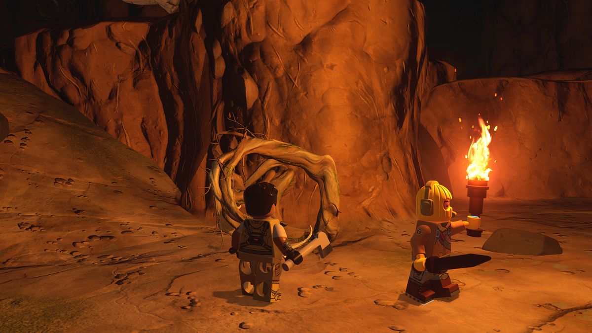 Lego Fortnite knotroot - two lego figures are inside a cave. One is holding a pickaxe and the other is holding a sword and a torch