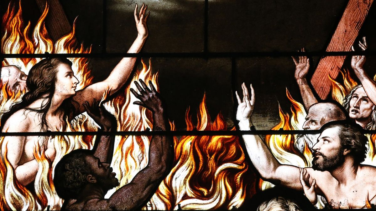 A stained glass window depicting people in Hell.