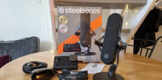 The SteelSeries Alias Pro with Stream Mixer and included cable, on a table with the packaging