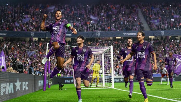 Players celebrate scoring a goal in the Football Manager 24 key art.