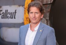 Todd Howard in front of a sign saying Fallout