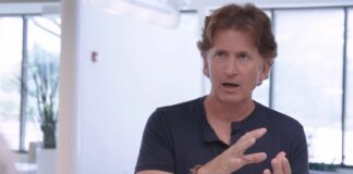 An image of Todd Howard in the middle of explaining a concept using hand gestures.