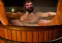 A shot of Geralt relaxing in the bath, his face overlaid with an amateur photoshop of Zoltan from The Witcher 1.