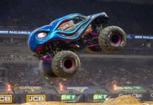 A Fortnite character standing beside a giant Monster Truck with the Monster Jam logo.