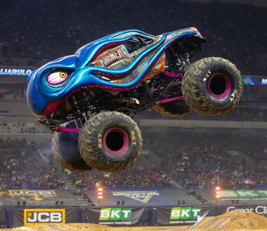 A Fortnite character standing beside a giant Monster Truck with the Monster Jam logo.